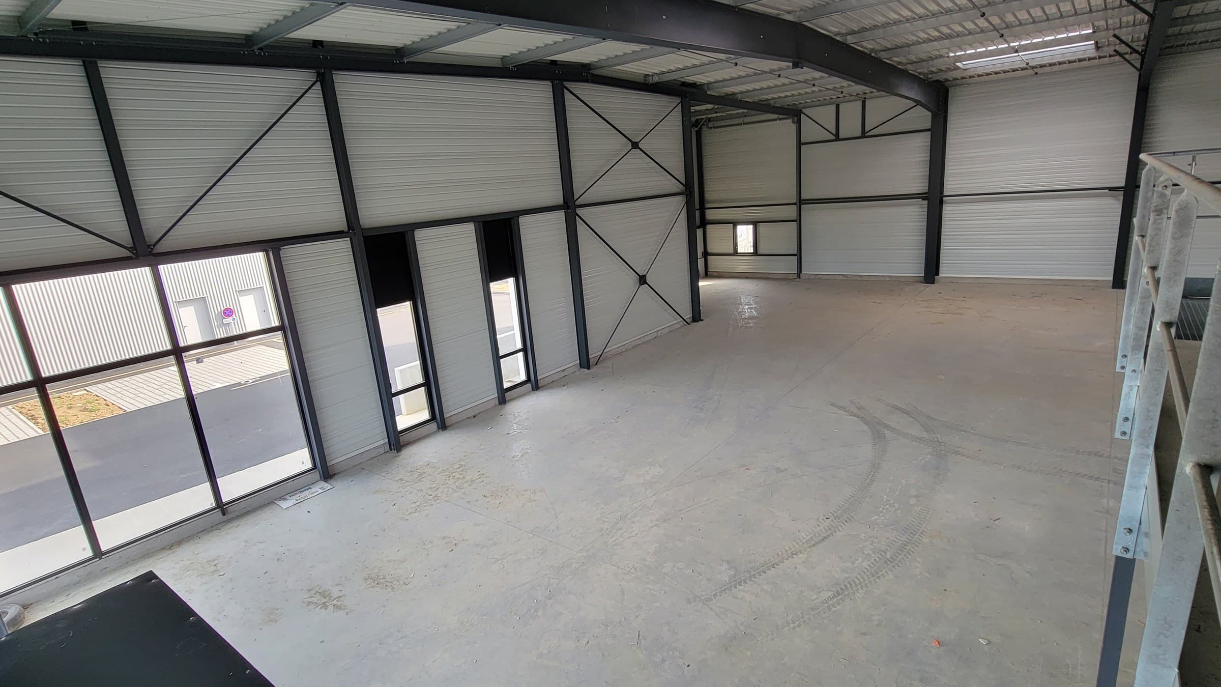 The bare 1,400 sqm shed before works, seen from the mezzanine