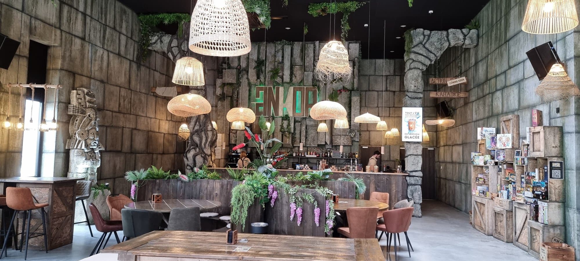 Ankor's central bar and sign, under the wicker pendant lights